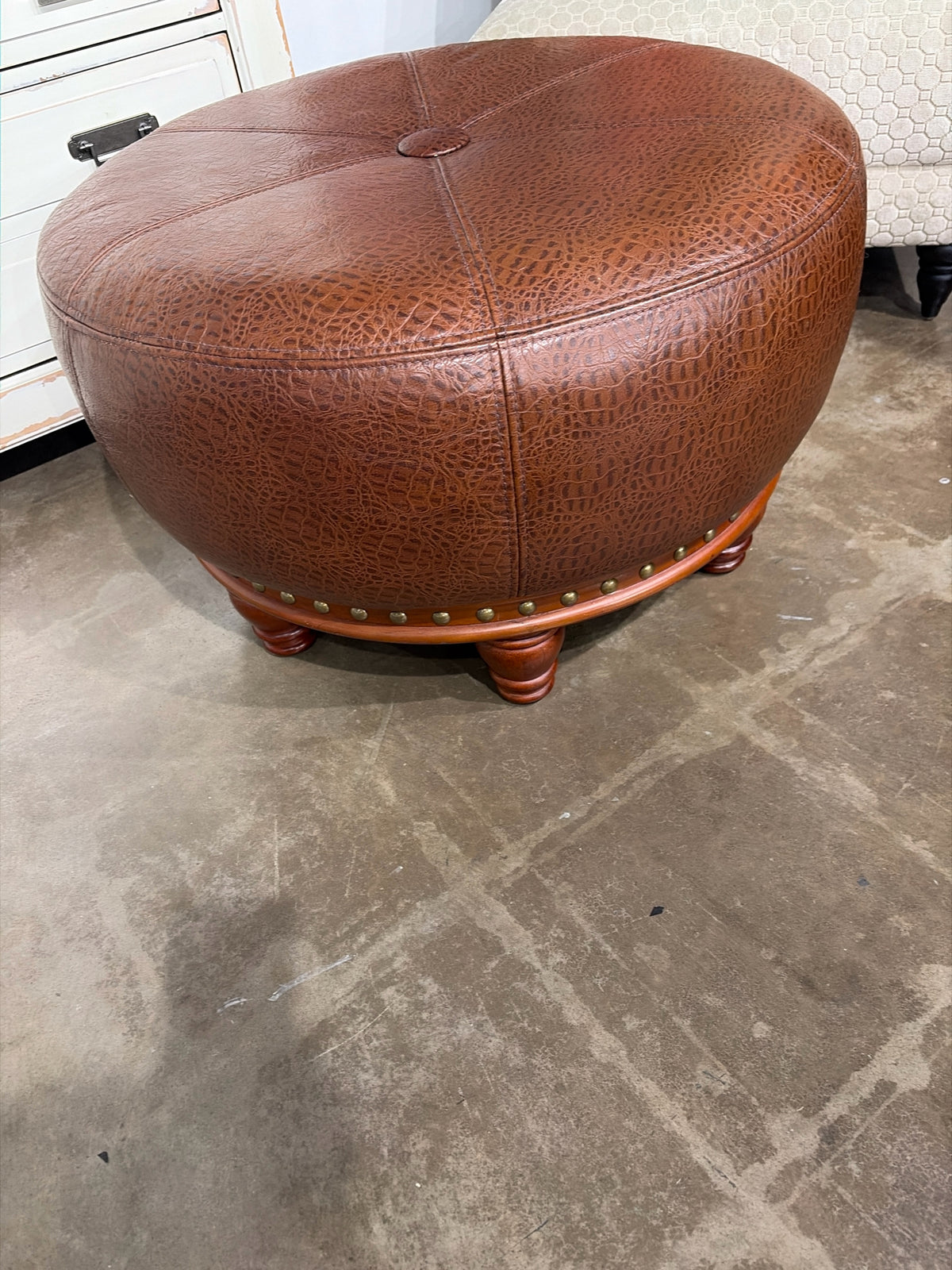 Round Faux Leather Ottoman With Nail Trim And Wood Feet 28" D